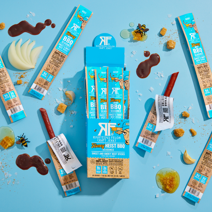 Honey heist BBQ Sticks 24ct caddy on blue background with ingredients 